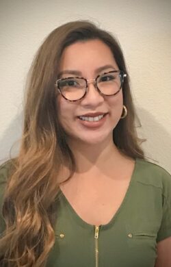 Photo of Leslie Garcia smiling, wearing a green shirt