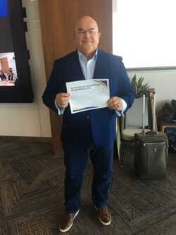 Fernando man holding sign in conference room