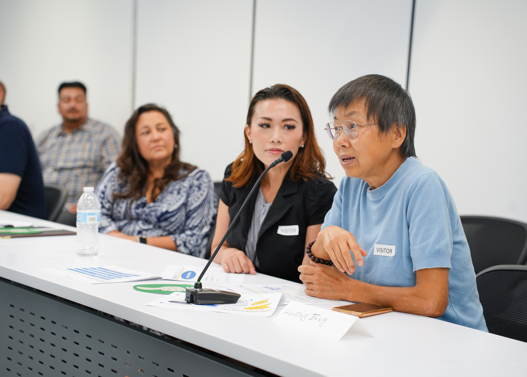 Man speaks on a phone set on a conference table.