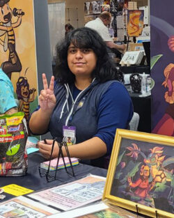 Janet Figueroa smiles at the camera while making the peace sign.