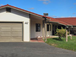 Front exterior of North STAR 2 showing the garage, covered entrance, and lawn.